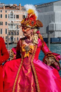 People in costume at the Venice carnival in front of the Madonna della Salute.