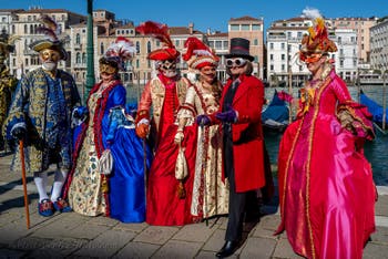 People in costume at the Venice carnival in front of the Madonna della Salute.