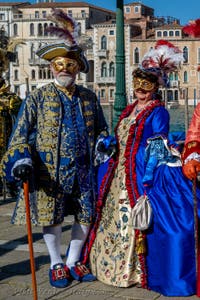 People in costume at the Venice carnival in front of the Madonna della Salute.