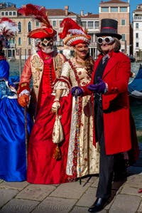 People in costume at the Venice carnival in front of the Madonna della Salute.