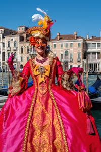 People in costume at the Venice carnival in front of the Madonna della Salute.