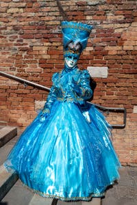 People in costume at the Venice carnival on Campiello Barbaro.