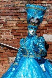 People in costume at the Venice carnival on Campiello Barbaro.