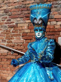 People in costume at the Venice carnival on Campiello Barbaro.