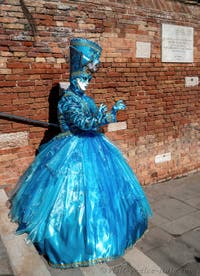 People in costume at the Venice carnival on Campiello Barbaro.