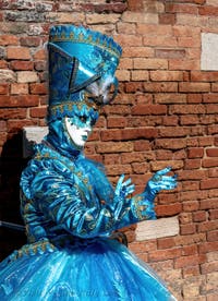 People in costume at the Venice carnival on Campiello Barbaro.