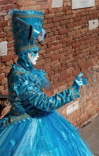 People in costume at the Venice carnival on Campiello Barbaro.