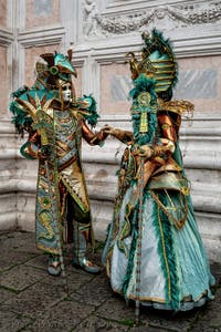 The parade of people in costume at the 2026 Venice Carnival in front of the Church of San Zaccaria.