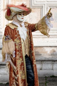 The parade of people in costume at the 2026 Venice Carnival in front of the Church of San Zaccaria.