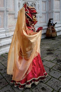 The parade of people in costume at the 2026 Venice Carnival in front of the Church of San Zaccaria.