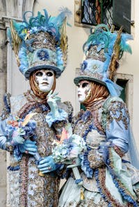 The parade of people in costume at the 2026 Venice Carnival in front of the Church of San Zaccaria.