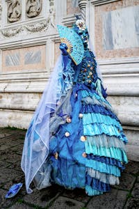 The parade of people in costume at the 2026 Venice Carnival in front of the Church of San Zaccaria.