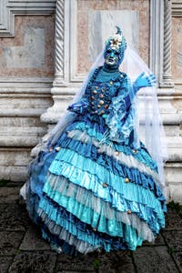 The parade of people in costume at the 2026 Venice Carnival in front of the Church of San Zaccaria.