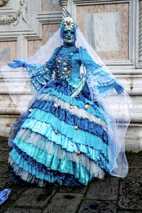 The parade of people in costume at the 2026 Venice Carnival in front of the Church of San Zaccaria.