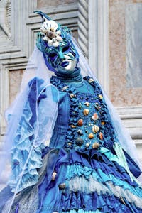 The parade of people in costume at the 2026 Venice Carnival in front of the Church of San Zaccaria.