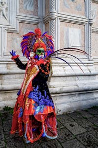 The parade of people in costume at the 2026 Venice Carnival in front of the Church of San Zaccaria.