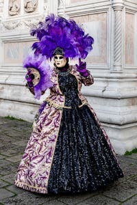 The parade of people in costume at the 2026 Venice Carnival in front of the Church of San Zaccaria.