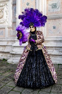 The parade of people in costume at the 2026 Venice Carnival in front of the Church of San Zaccaria.