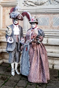 The parade of people in costume at the 2026 Venice Carnival in front of the Church of San Zaccaria.