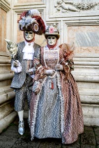 The parade of people in costume at the 2026 Venice Carnival in front of the Church of San Zaccaria.