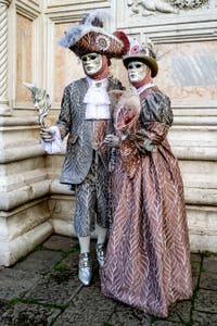 The parade of people in costume at the 2026 Venice Carnival in front of the Church of San Zaccaria.