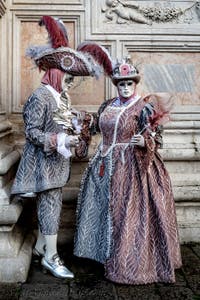 The parade of people in costume at the 2026 Venice Carnival in front of the Church of San Zaccaria.