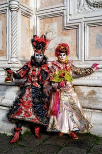 The parade of people in costume at the 2026 Venice Carnival in front of the Church of San Zaccaria.