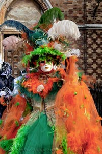 The parade of people in costume at the 2026 Venice Carnival in front of the Church of San Zaccaria.