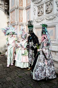 The parade of people in costume at the 2026 Venice Carnival in front of the Church of San Zaccaria.