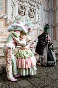 The parade of people in costume at the 2026 Venice Carnival in front of the Church of San Zaccaria.