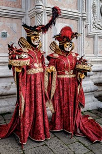 The parade of people in costume at the 2026 Venice Carnival in front of the Church of San Zaccaria.