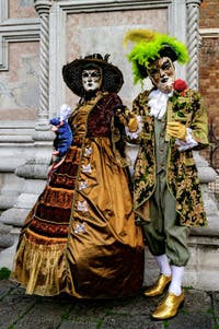 The parade of people in costume at the 2026 Venice Carnival in front of the Church of San Zaccaria.