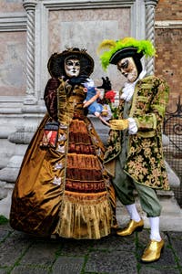 The parade of people in costume at the 2026 Venice Carnival in front of the Church of San Zaccaria.