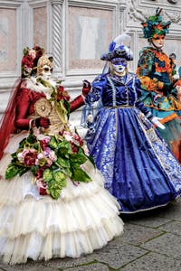 The parade of people in costume at the 2026 Venice Carnival in front of the Church of San Zaccaria.