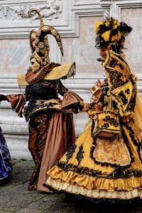The parade of people in costume at the 2026 Venice Carnival in front of the Church of San Zaccaria.