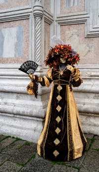 The parade of people in costume at the 2026 Venice Carnival in front of the Church of San Zaccaria.