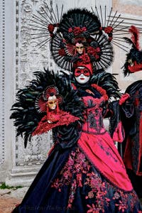 The parade of people in costume at the 2026 Venice Carnival in front of the Church of San Zaccaria.