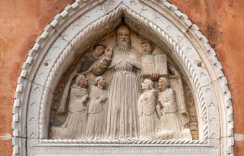 Tabernacle lunette representing Saint Augustine surrounded by his monks, made by Bartolomeo Bellano in the 15th century, Cloister of Santo Stefano in the Saint Mark's District in Venice