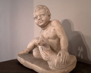 A seated child holding a goose, Archaeological Museum of Naples, Italy